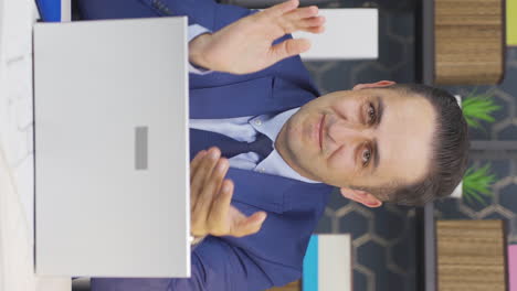 Vertical-video-of-Businessman-clapping-while-looking-at-camera-with-pride-and-joy.