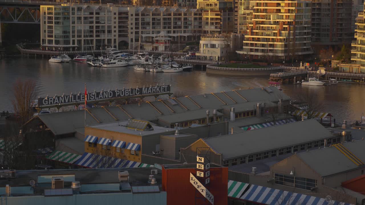 Panoramic view Granville Island Public Market at dusk with its calm surrounding waters and the cityscape in the background inlet ocean vancouver bc sunset