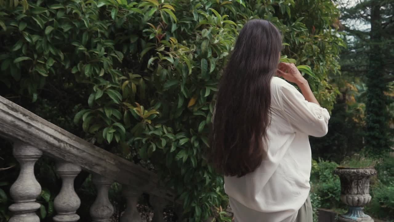 역사적인 정원에서 고 있는 여자