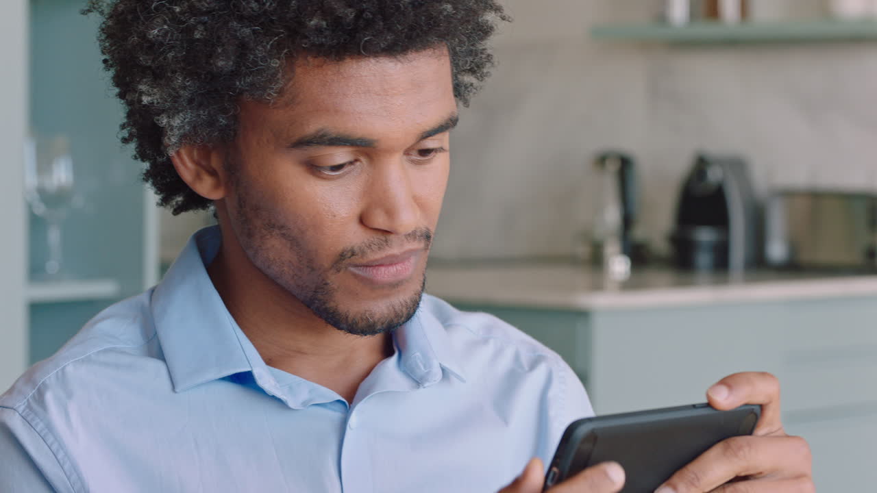 young man using smartphone texting social media messages browsing online enjoying mobile communication at home