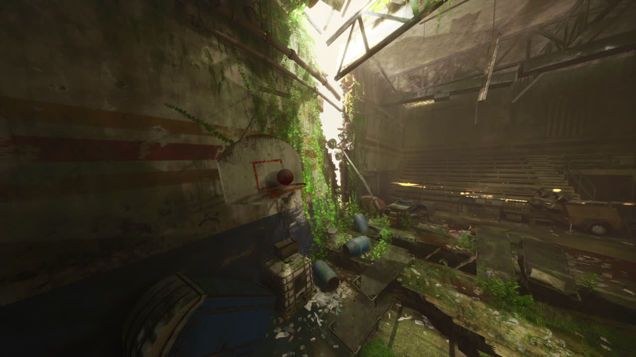 An old basketball rests in a decaying gym overtaken by nature and time