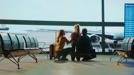 family at the airport watching planes