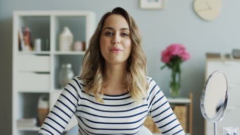 Beautiful-Woman-Sitting-In-Front-Of-Camera-In-A-Nice-Room-And-Recording-A-Video-For-Her-Blog