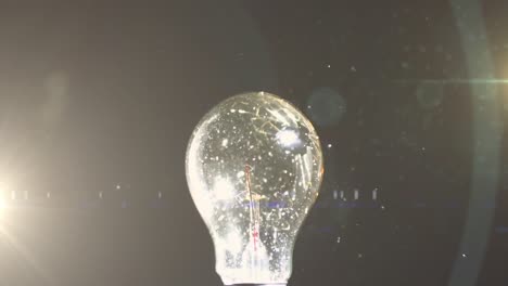 Animation-of-light-bulb-glowing-networks-hit-by-ball-and-copy-space