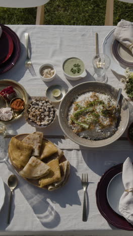an outdoor indian feast with a variety of dishes