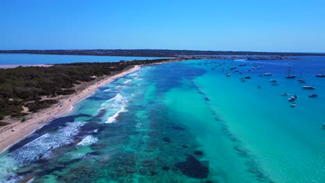 scenic aerial view of rocky island formentera's turquoise azur waters and sandy beaches. fabulous aerial view flight fly reverse drone