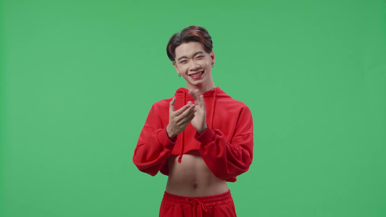 Young Asian Transgender Male Clapping Her Hands In The Green Screen Studio