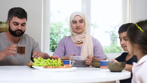 Close-up-view-of-islamic-family-having-breakfast.