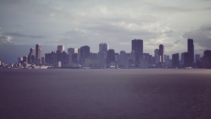 City skyline under a cloudy sky viewed from the water in late afternoon light