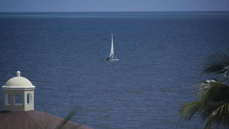 sailboat floating slowly in the ocean