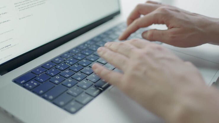 Person Typing on Laptop