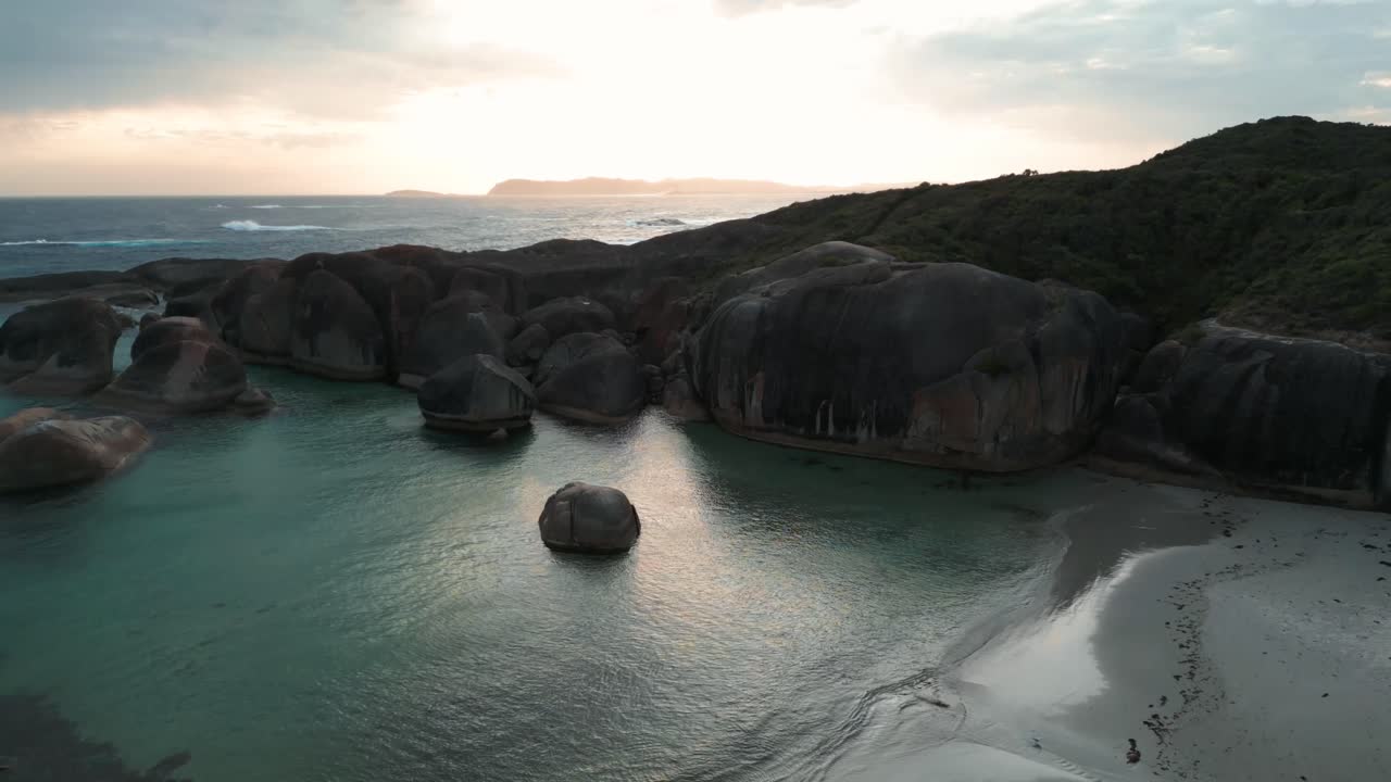 aerial descending drone shot above Elephant Rocks in Williams Bay national Park in Western Australia at sunset