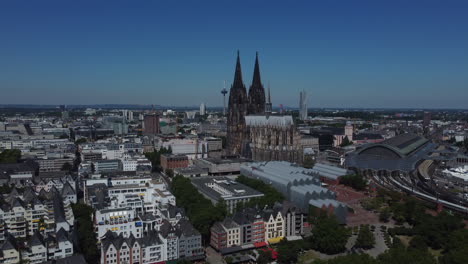 drone shot of the kölner dom - drone is moving away from the dome with the tv tower and central station in sight