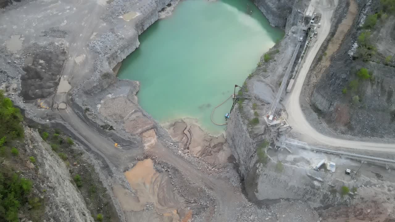 Flyaway shot of a rock quarry, displaying a beautiful sunset sky