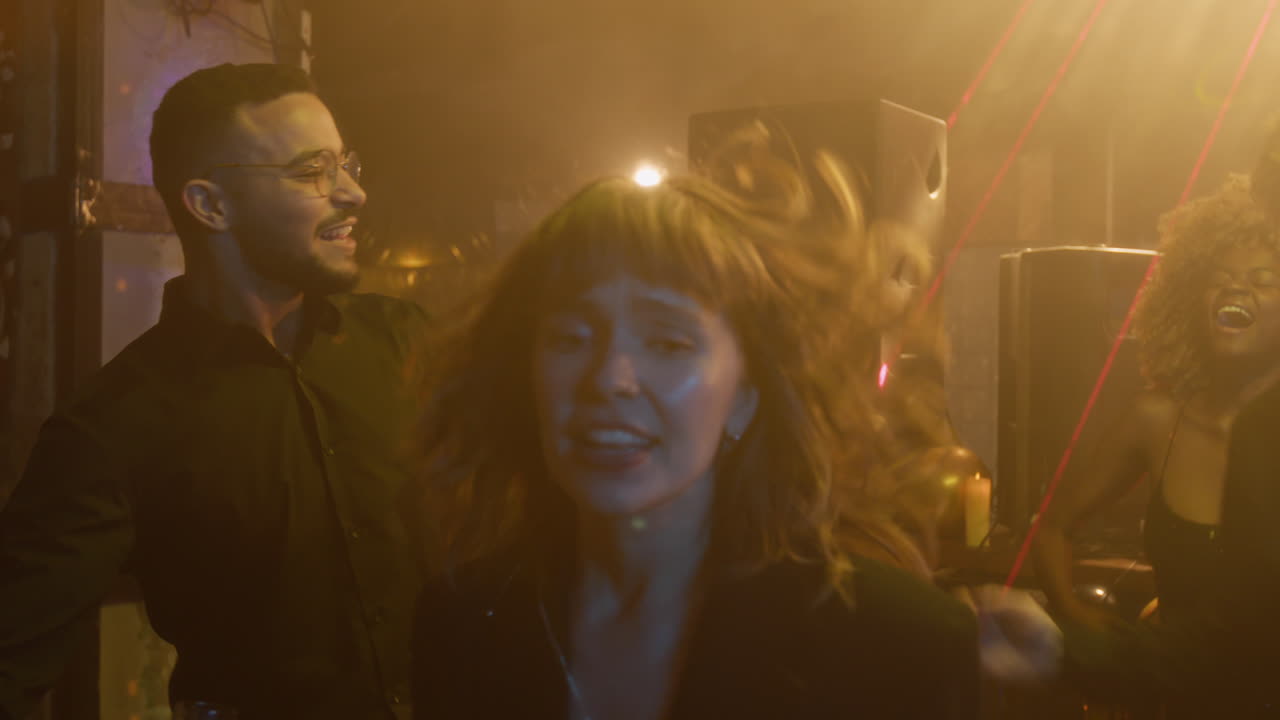 People celebrating and dancing at a party or club