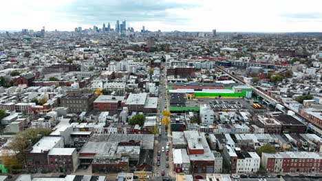 aerial of kensington, north philadelphia with city skyline in distance