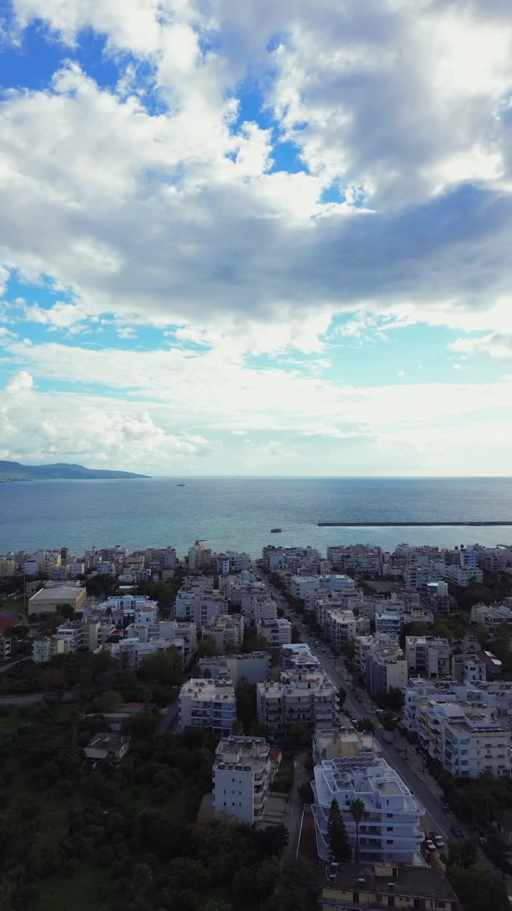 Aerial vertical high angle view of Messinian gulf on a cloudy autumn day, taken from Kalamata, Peloponnese , Greece. Right pan wide view 4K