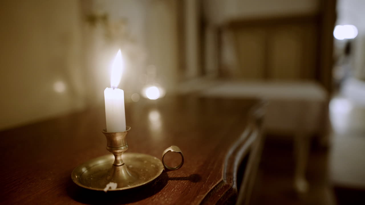 Antique Candle Burning on Desk