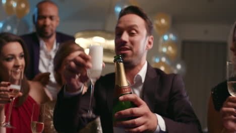 friends holding up champagne flutes together in a toast at party