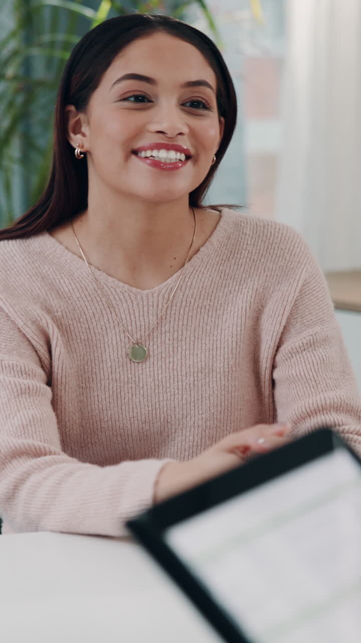 Young Woman Talking and Gesturing During a Business Meeting