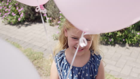 little blonde girl running with balloons in slow motion