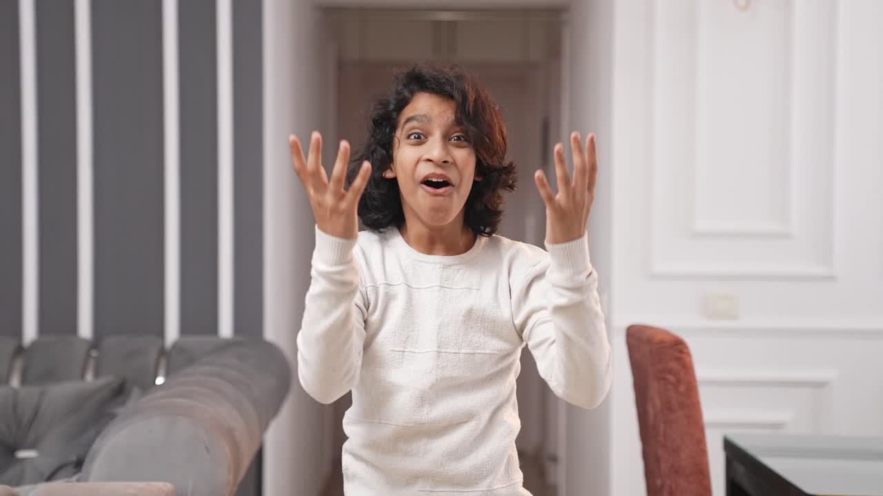Happy and smiling Indian kid teenager boy getting surprised