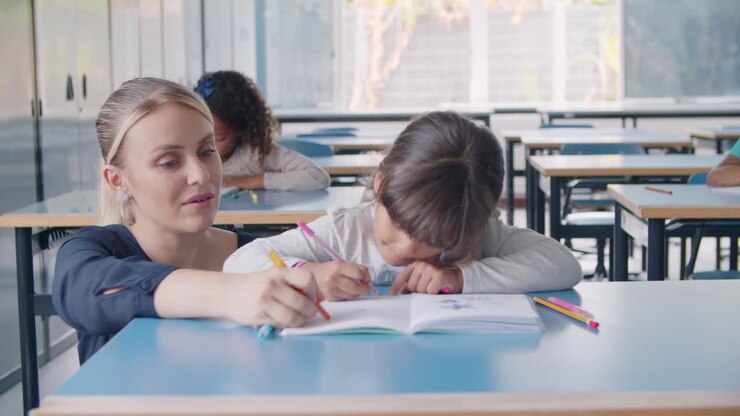 Primary school teacher showing and explaining task