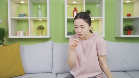 asian young woman suffering from shortness of breath at home.