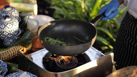 slow motion, frying pan tossing vegetables during sunset