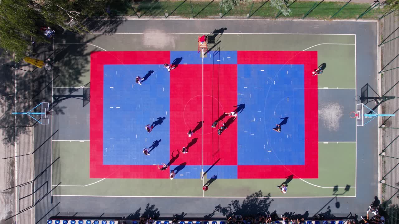 Top Down Aerial View of Teams Playing Volleyball on Outdoor Court in City Park on Sunny Day
