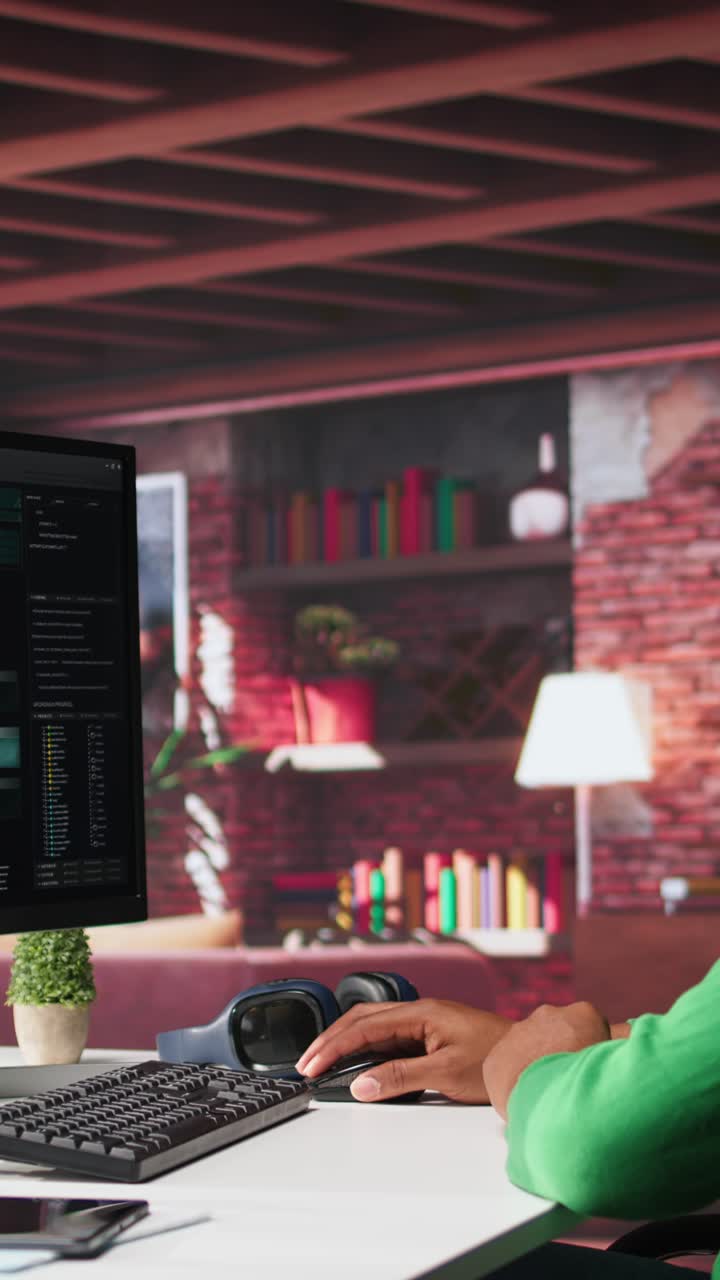 Vertical Video African american man looking at UI on PC screen at home office