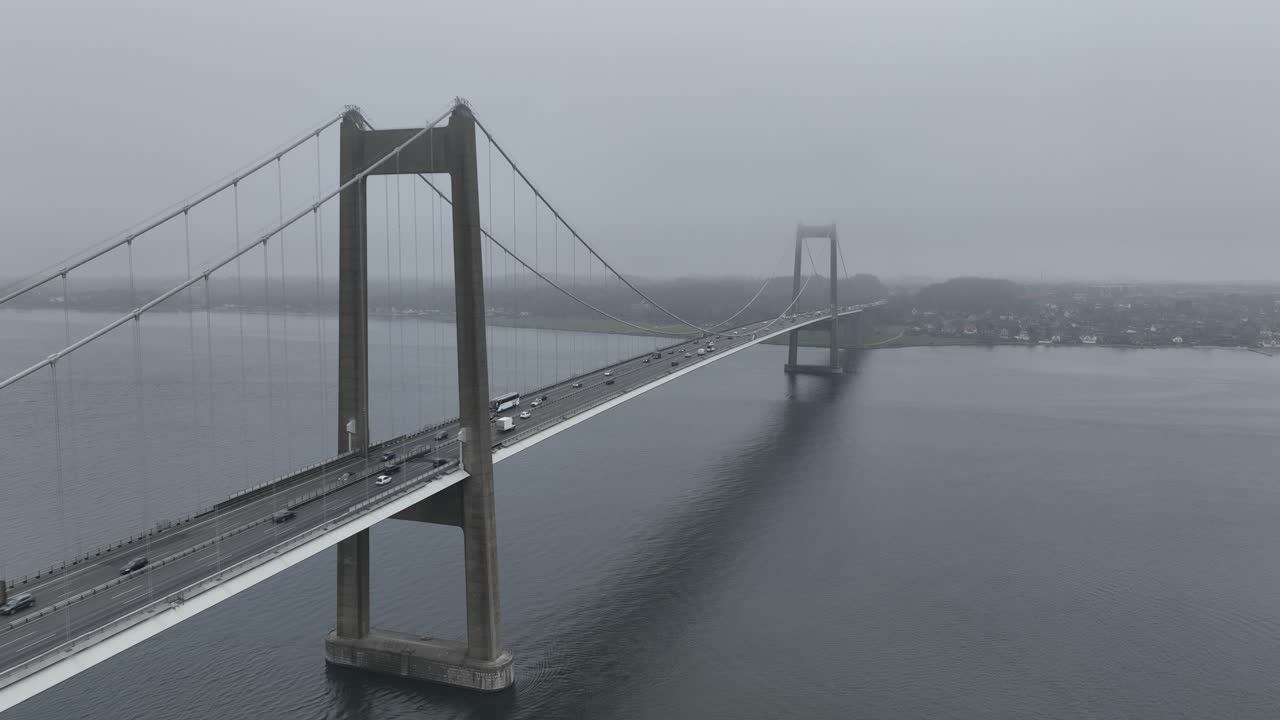 New Little Belt Bridge, suspension bridge that crosses the Little Belt strait between Jutland Jylland and the island of Funen. foggy weather, aerial view.