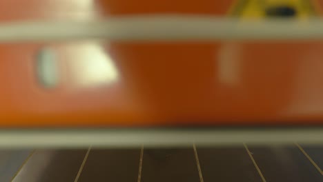 a wood chair being shaped in a industrial press machine, manufacturing industrial technology