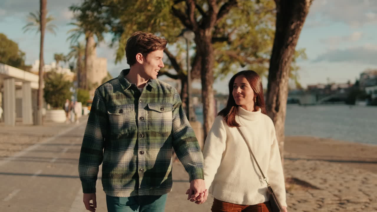 Couple Strolling Along the Guadalquivir River in Seville