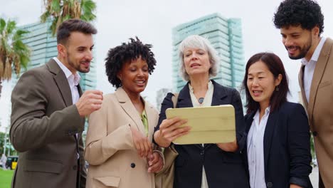 diverse business team collaborating on a tablet in the city