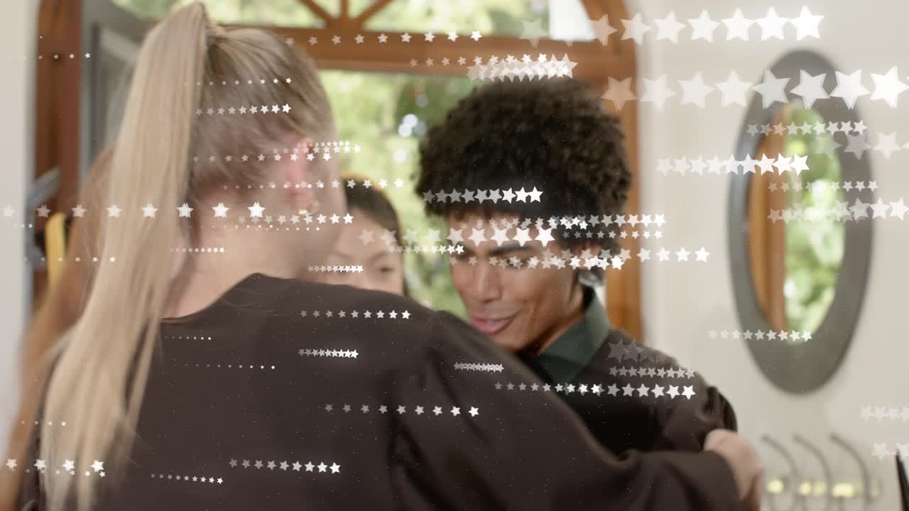 Graduates entering entryway hugging and celebrating while animated stars overlay gowns and phone