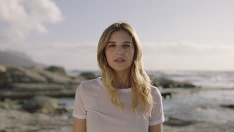 portrait of beautiful young blonde woman smiling blissful at beach