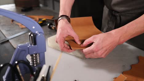 leatherworking process: detail view of hand-crafting