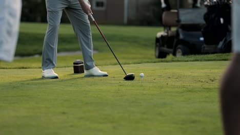 slow motion golfer hits a ball of the tee