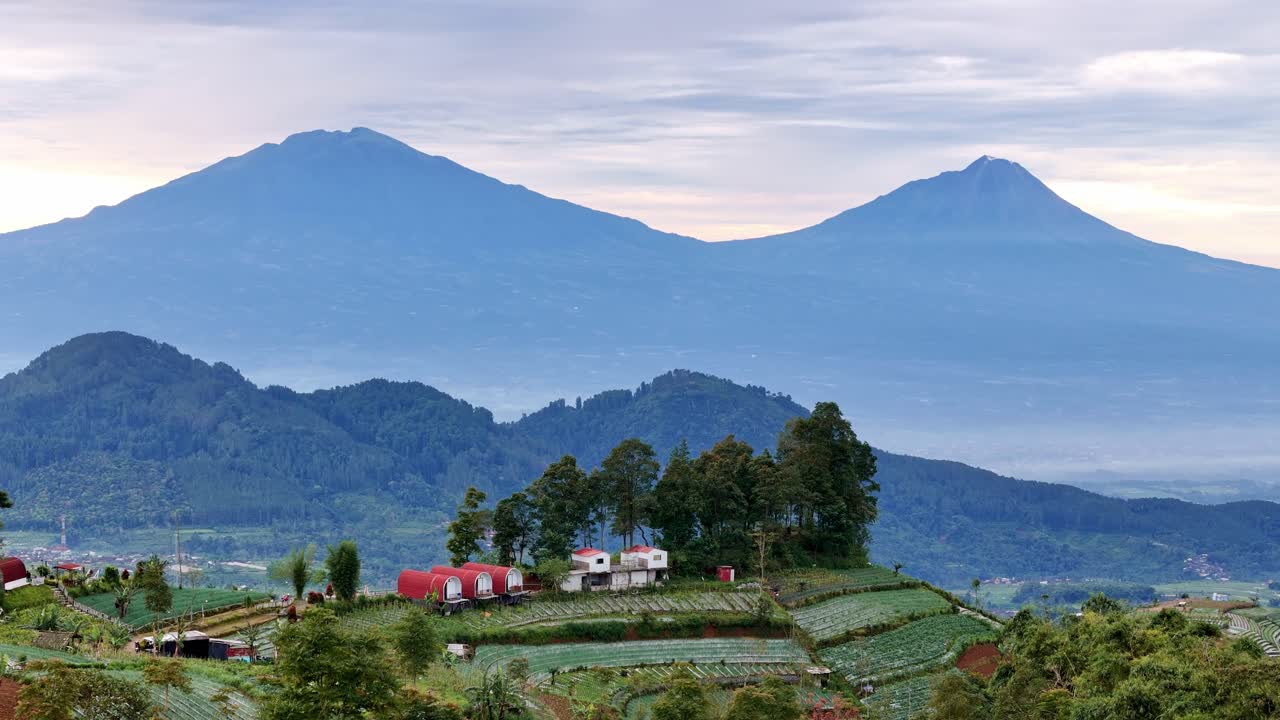 Beautiful house scenery on the highland with mountain background. Amazing view of rural landscape.
