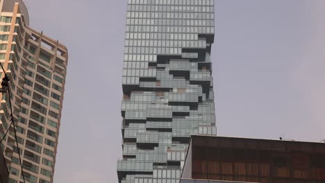 jagged-modern-architecture-of-the-MahaNakhon,-King-power-skyscraper-in-downtown-Bangkok,-the-capital-city-of-Thailand