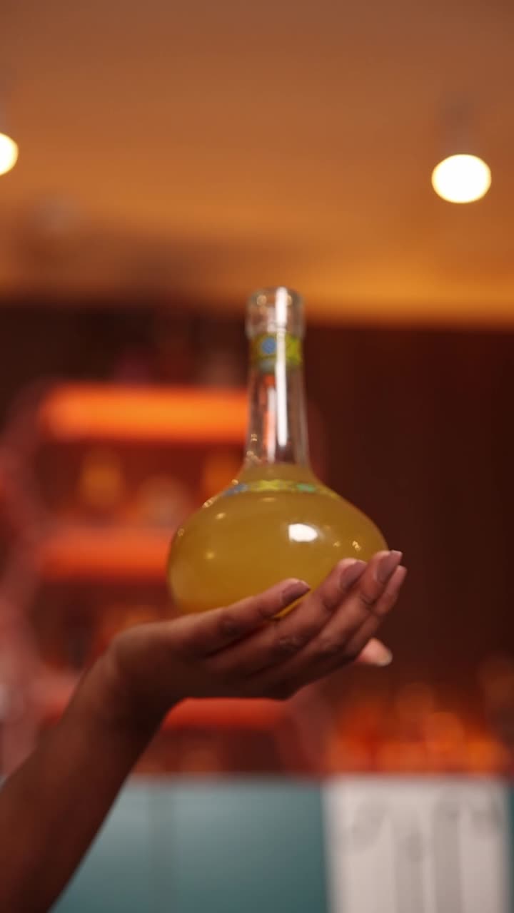 Cocktail in a bottle held in hand