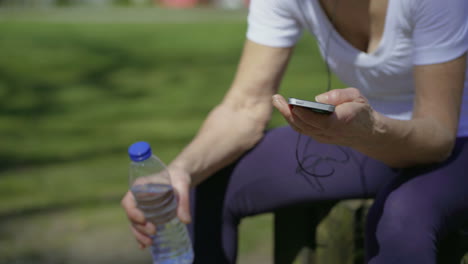 senior sportswoman using smartphone.