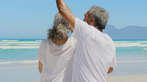 Front-view-of-romantic-active-senior-African-American-couple-dancing-together-on-the-beach-4k