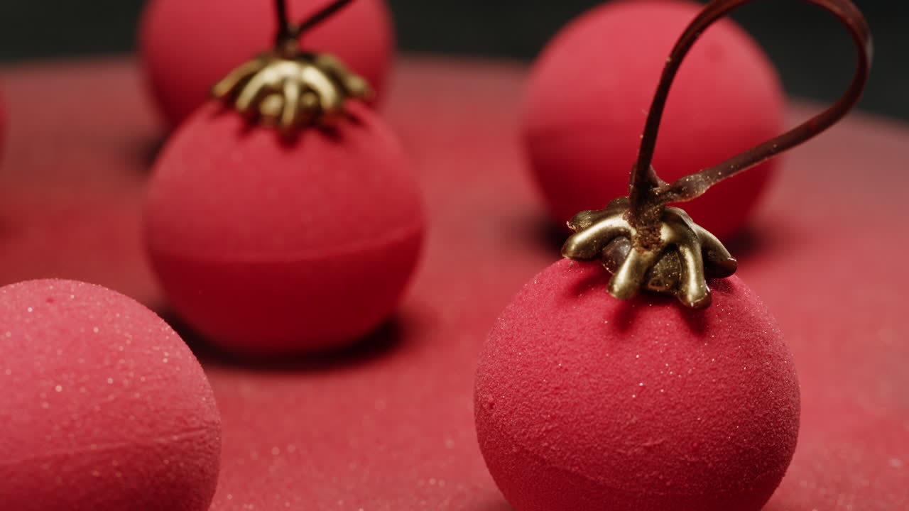 Handcrafted Red Sphere Desserts with Gold Accents