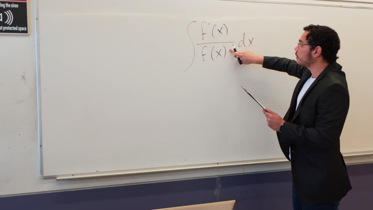 Man with Clipboard in a Classroom Environment