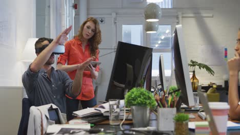 Businessman-wearing-VR-helmet-in-modern-office