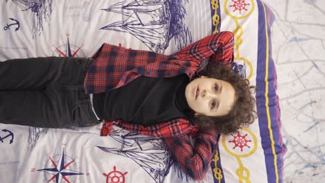 curly haired boy using his imagination.