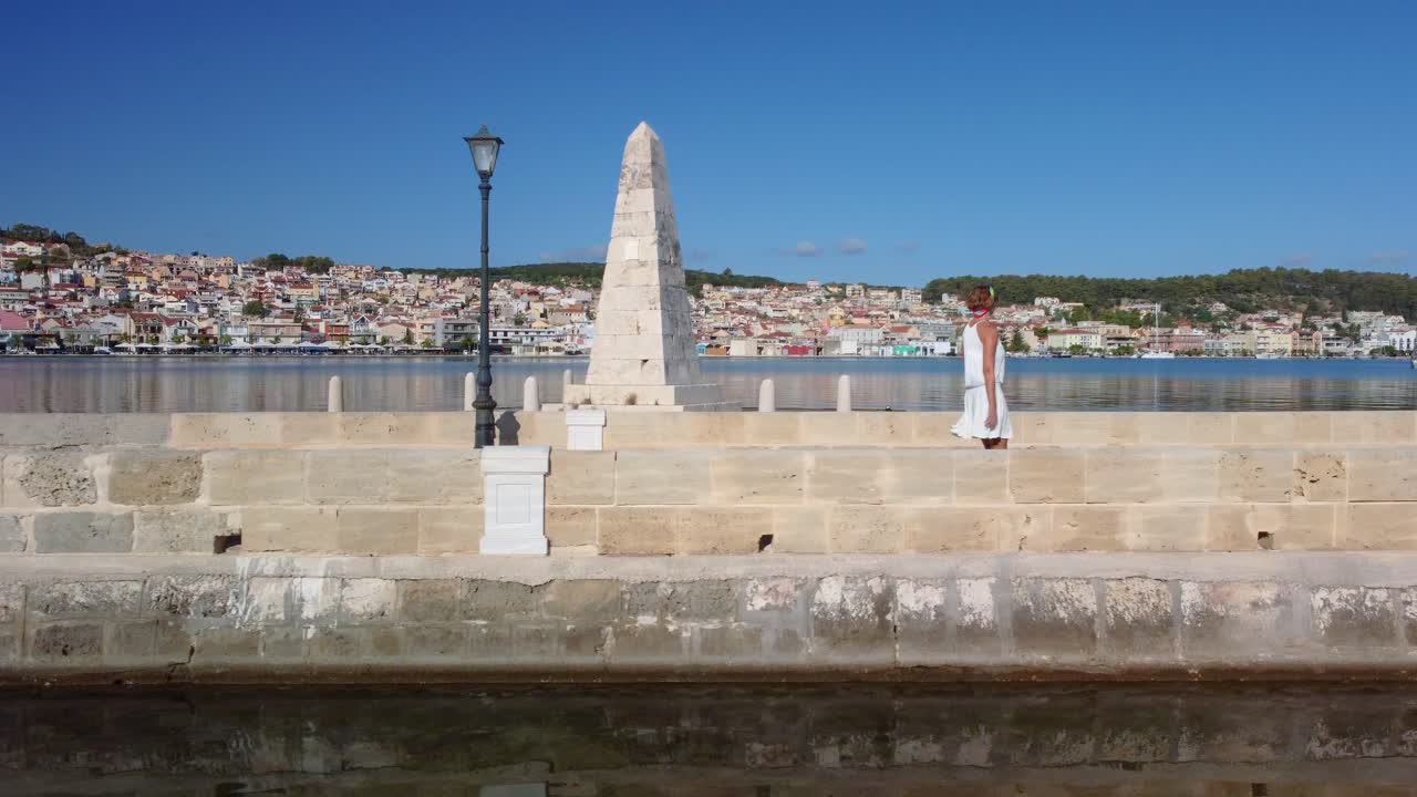 Woman walking on the De Bosset  in Argostoli, Kefalonia, Greece