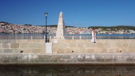 woman walking on the de bosset  in argostoli, kefalonia, greece